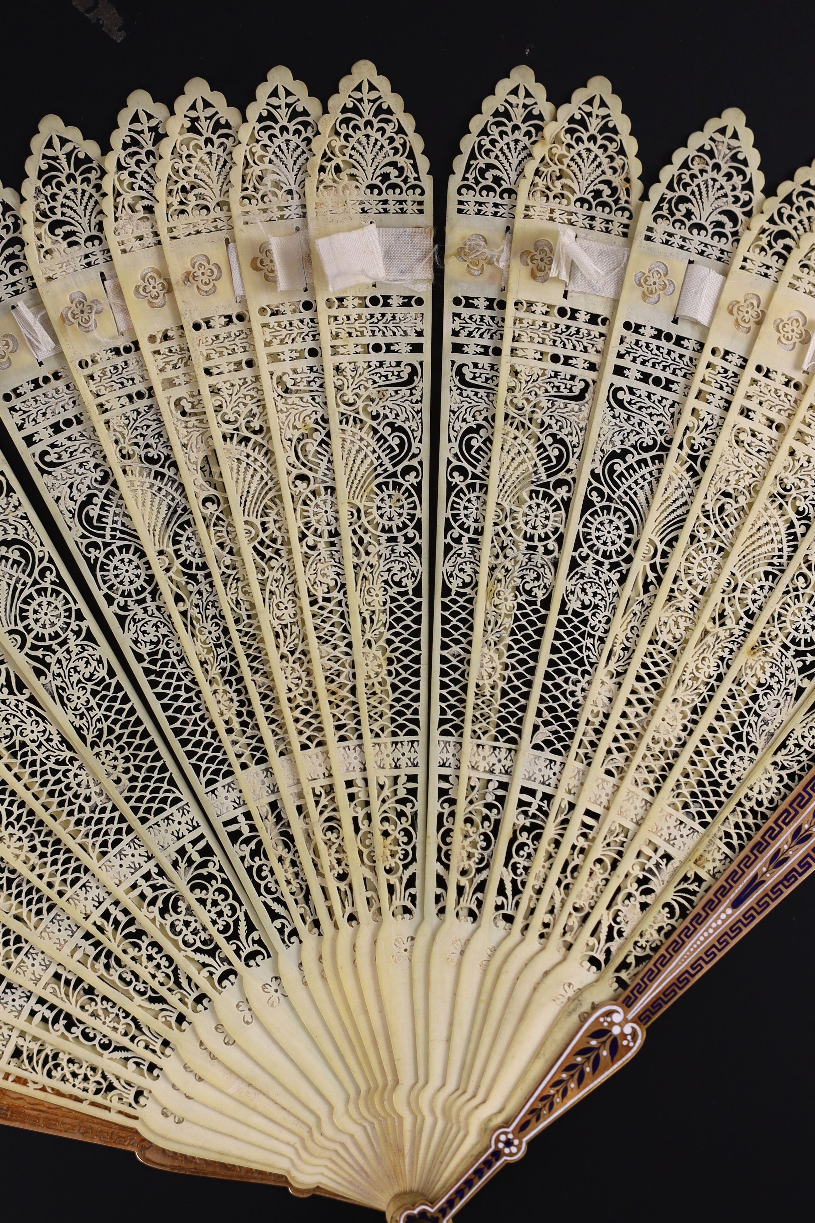 A German or Swiss gold, enamel and ivory brise fan, 19th century, possibly made for the Ottoman market, 17.3 cm closed, slight losses to sticks, needs rethreading